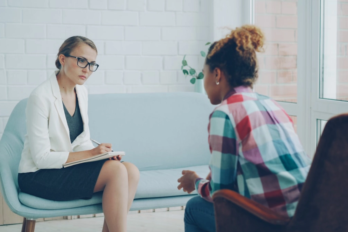A CalmCare psychiatric provider listening attentively during a patient session